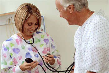 Nurse taking man's blood pressure